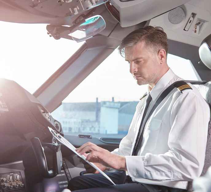 Pilot reviewing flight checklist tablet